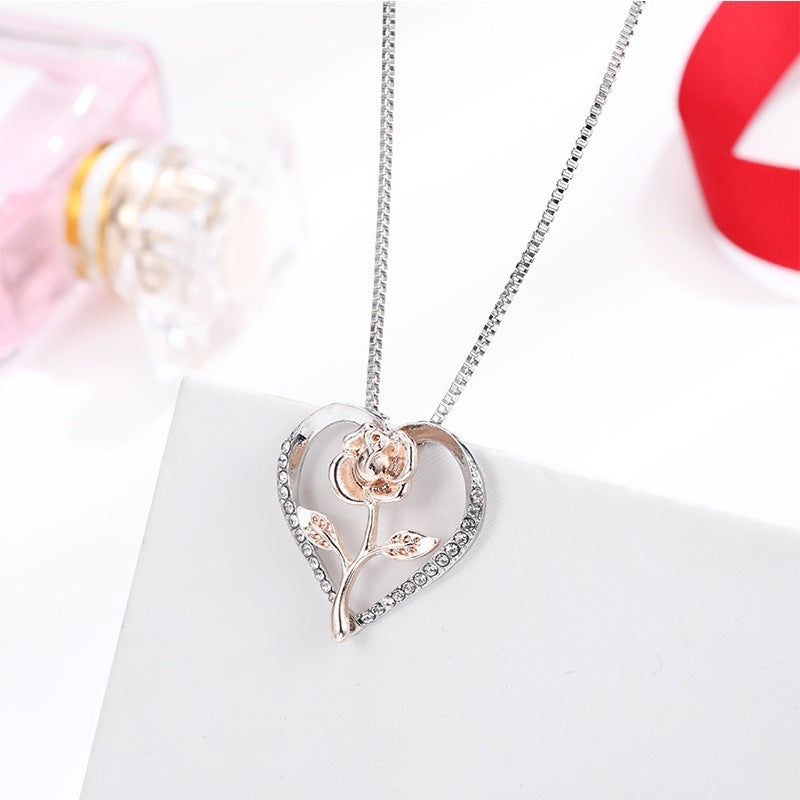 Zircon Heart Rose Silver Necklace for Women elegantly displayed on a white surface with a pink perfume bottle in the background.