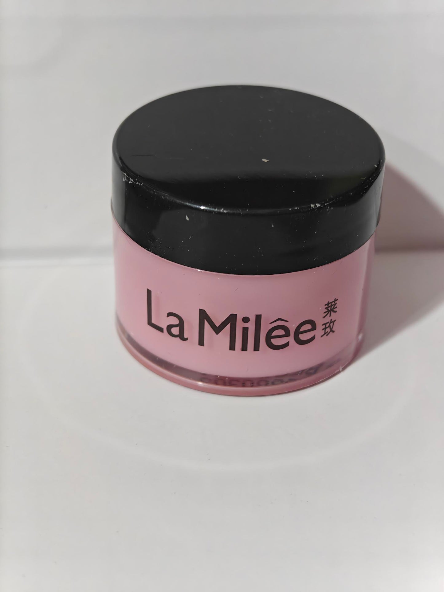 Moisturizing lip care products in a pink jar by La Milée for nourishing and hydrating lips.