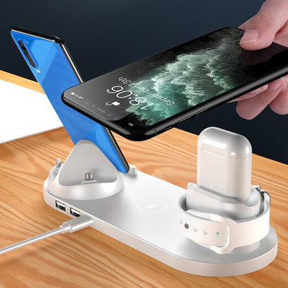 6 in 1 wireless charging dock for iPhone with phone, AirPods, and watch charging simultaneously on a wooden table.