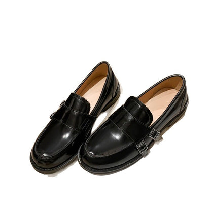 Retro distressed brown leather shoes in black color with chunky heel and belt buckle design.