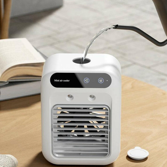 Portable Air Cooler Fan with Water Cooling on a wooden table beside an open book