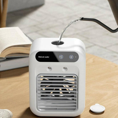 Portable Air Cooler Fan with Water Cooling on a wooden table beside an open book