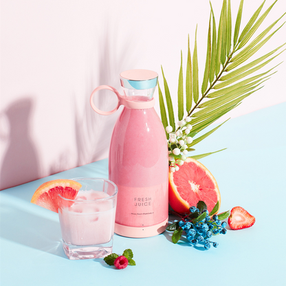 Portable Juicer Blender with fresh juice and fruits on a pastel background, showcasing a healthy drink option.