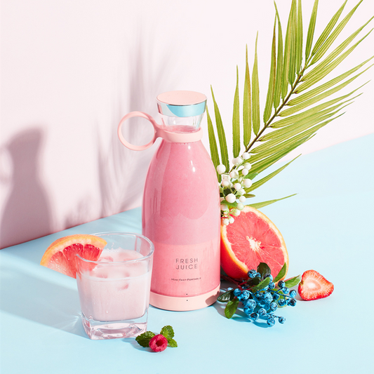 Portable Juicer Blender with fresh juice and fruits on a pastel background, showcasing a healthy drink option.
