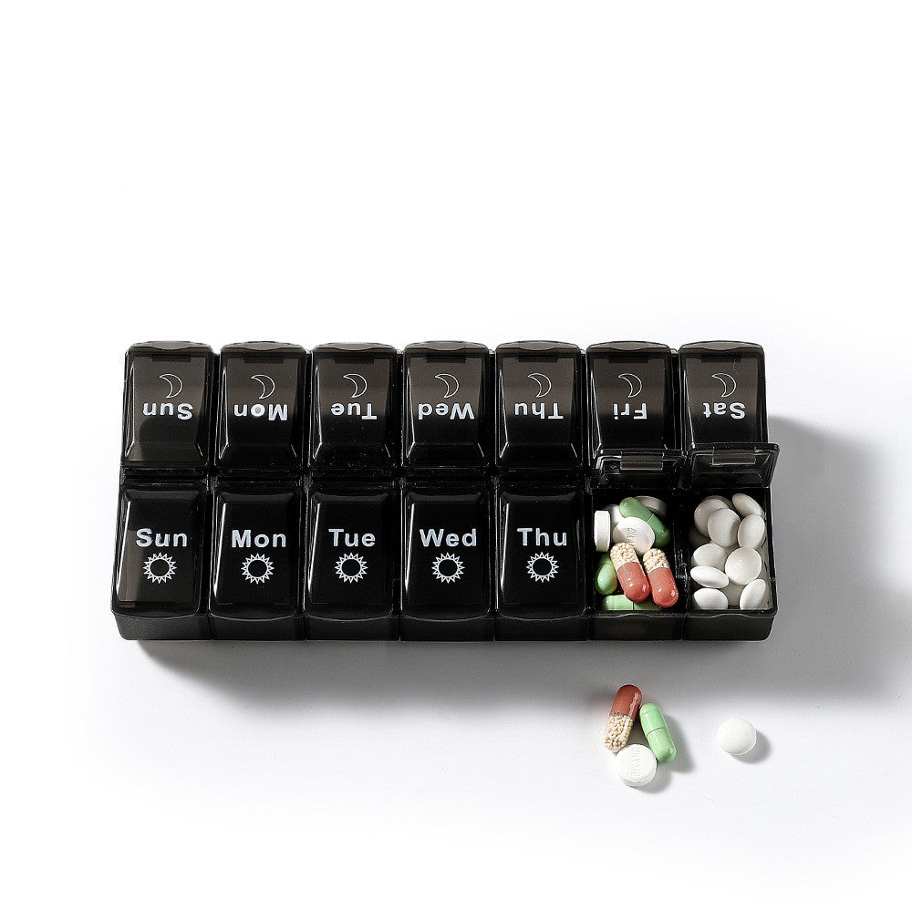 Black and white two-color large capacity detachable pill box for storing seven-day pills.