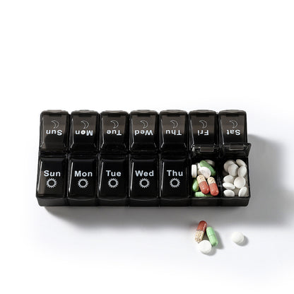 Black and white two-color large capacity detachable pill box for storing seven-day pills.