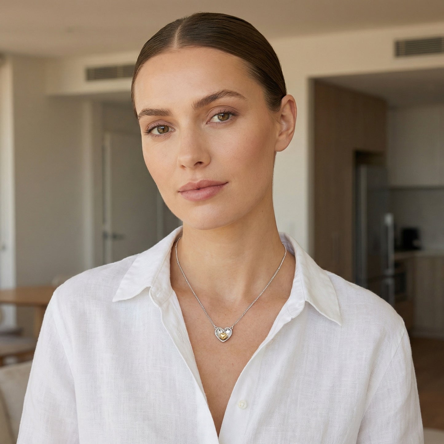 Model wearing a 925 Sterling Silver nested heart pendant necklace with two-tone accents.