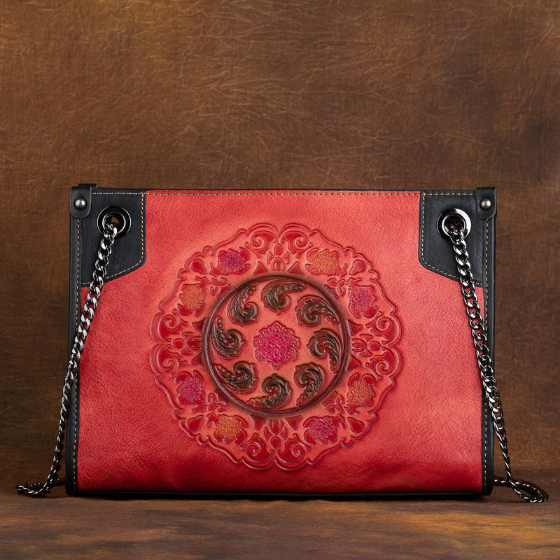 Large capacity leather tote bag with embossed pattern in vintage red color.