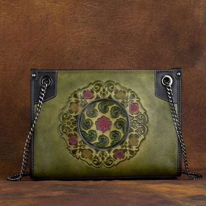 Large capacity leather tote bag in green with intricate embossed floral pattern and chain straps.
