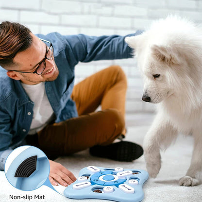 Person playing with dog using dog interactive puzzle toys on a non-slip mat for mental stimulation.