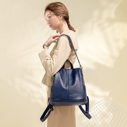 Large-capacity anti-theft leather backpack worn by a woman in a stylish outfit.
