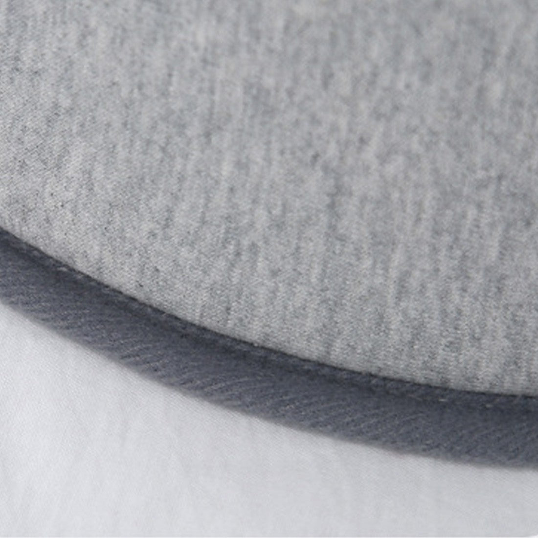 Close-up of the soft modal cotton fabric edge of a baby bed for acid reflux, highlighting comfort and breathability.