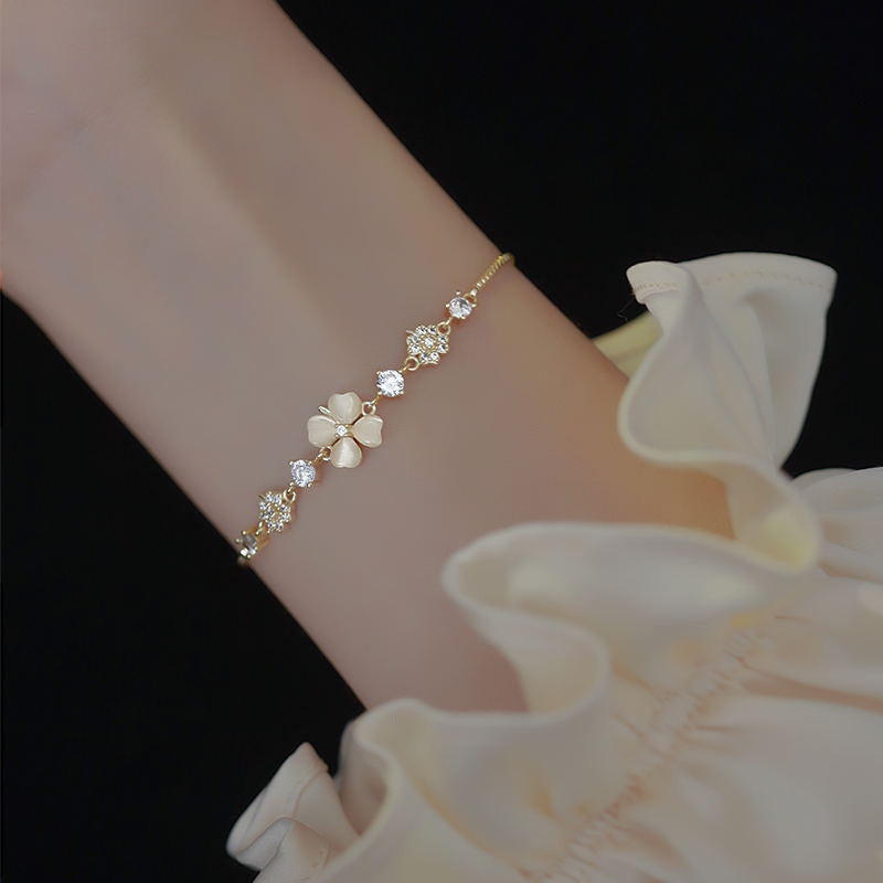 Versatile Japanese and Korean minimalist cat eye stone bracelet worn on a wrist with floral design and elegant details.
