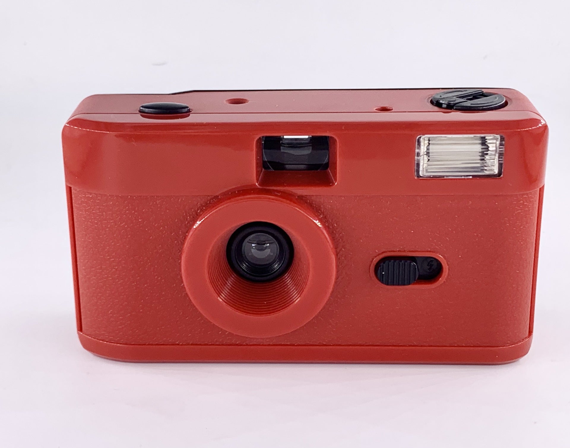 Non-disposable retro film camera in vibrant red color with built-in flash and 35mm film format.