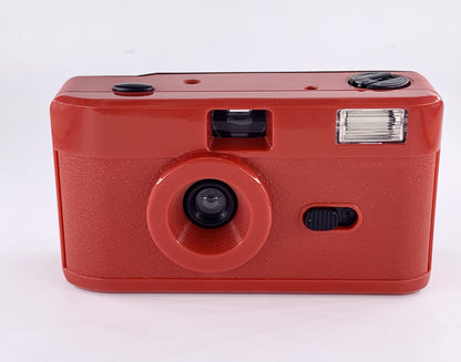 Non-disposable retro film camera in vibrant red color with built-in flash and 35mm film format.