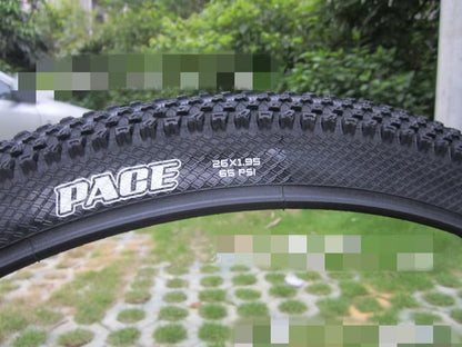 ultralight puncture proof mountain bike tire with 26x1.95 size and 65 psi air pressure displayed on the sidewall.