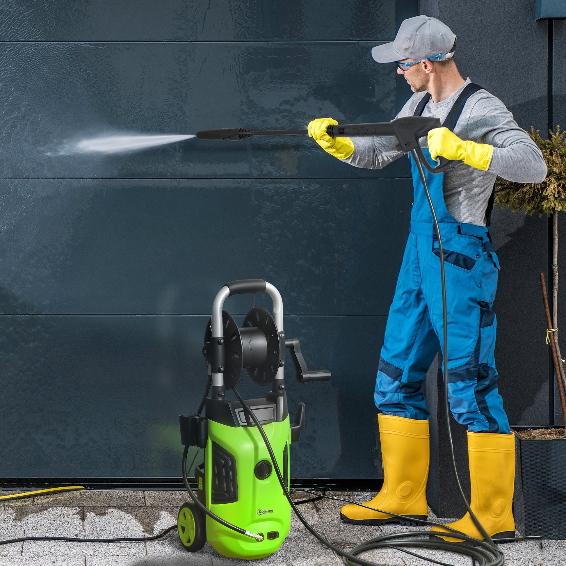 Man using portable high pressure washer 1800W to clean a wall with powerful water jet.