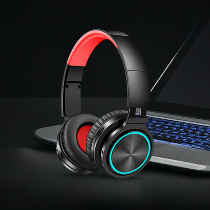 Wireless Headphones with over-ear design and stylish red accents placed next to a laptop.