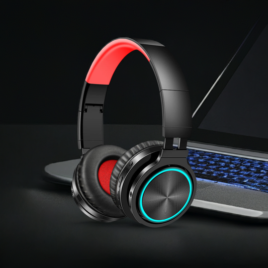 Wireless Headphones with over-ear design and stylish red accents placed next to a laptop.